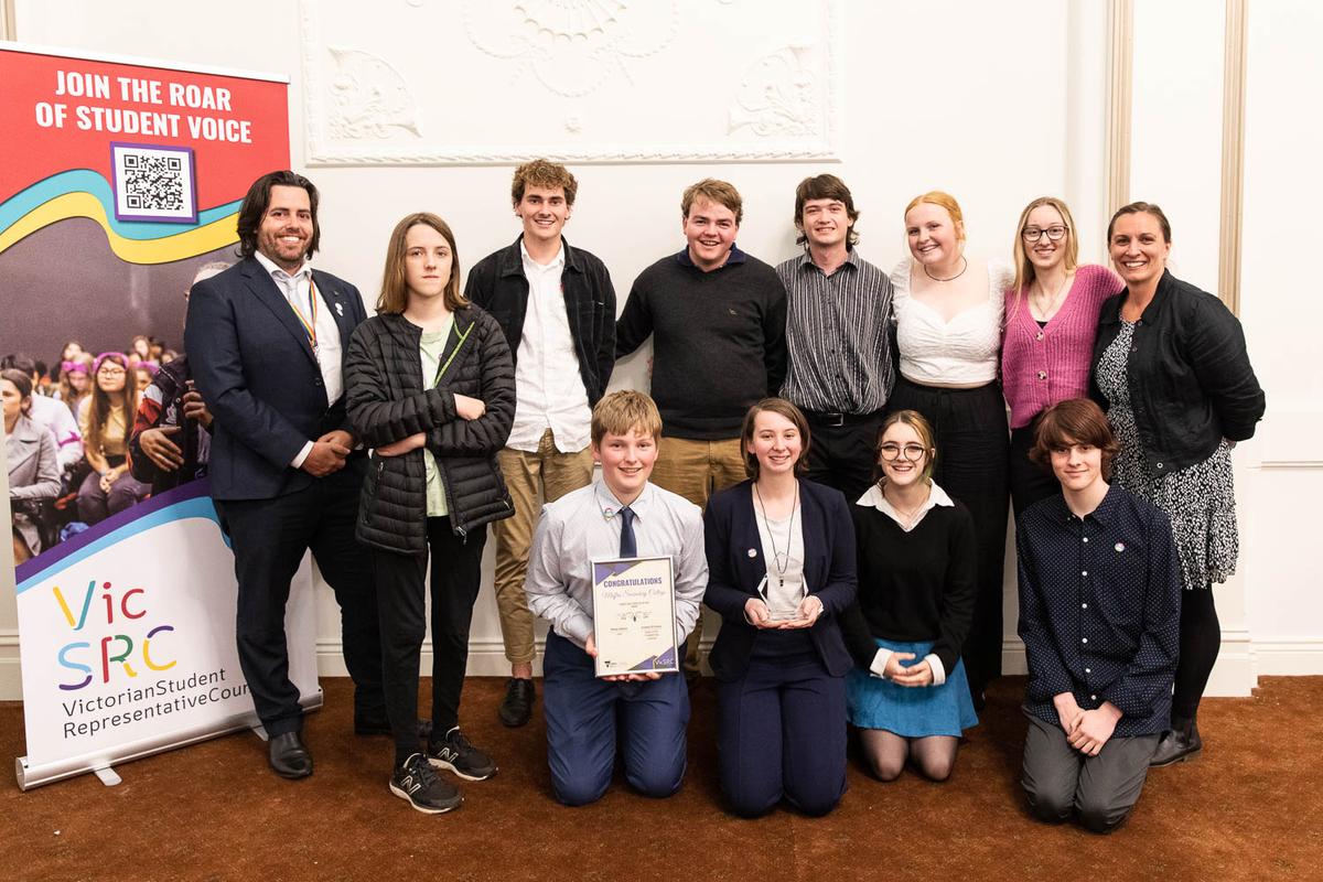 A group of students and teachers from Maffra Secondary College holding their certificate and trophy.