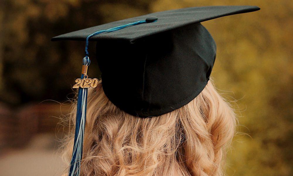 A photo taken of the back of a student's head, they are wearing a graduation cap marked 2020.
