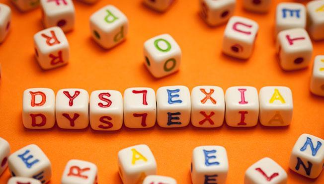 Small cubes with letters on each side spell out dyslexia.